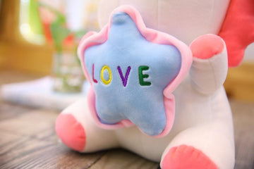 unicorn soft toy with a word love