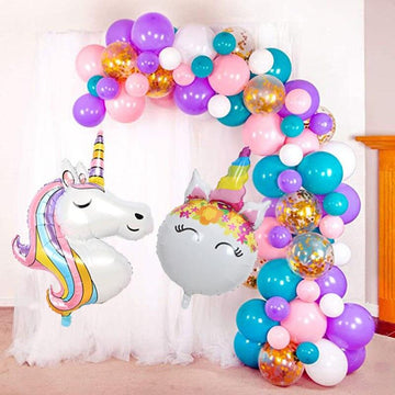 Garland of large multicolored unicorn balloons in an arch for birthday